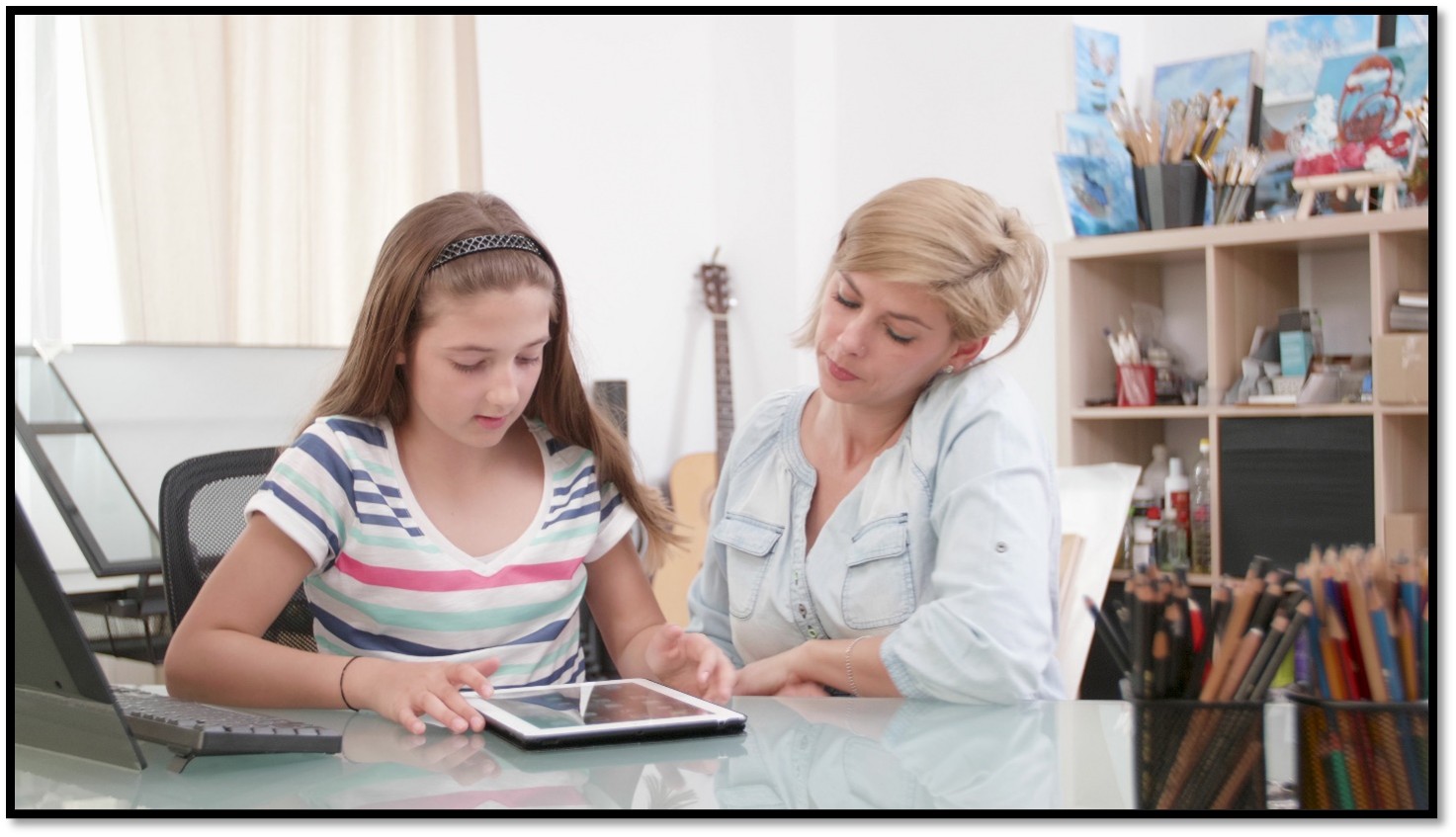 Therapist guiding a child using autism therapy software on a tablet